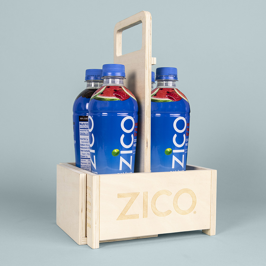 Image of Zico coconut water bottles in a convertible multi-use branded wooden carrier case